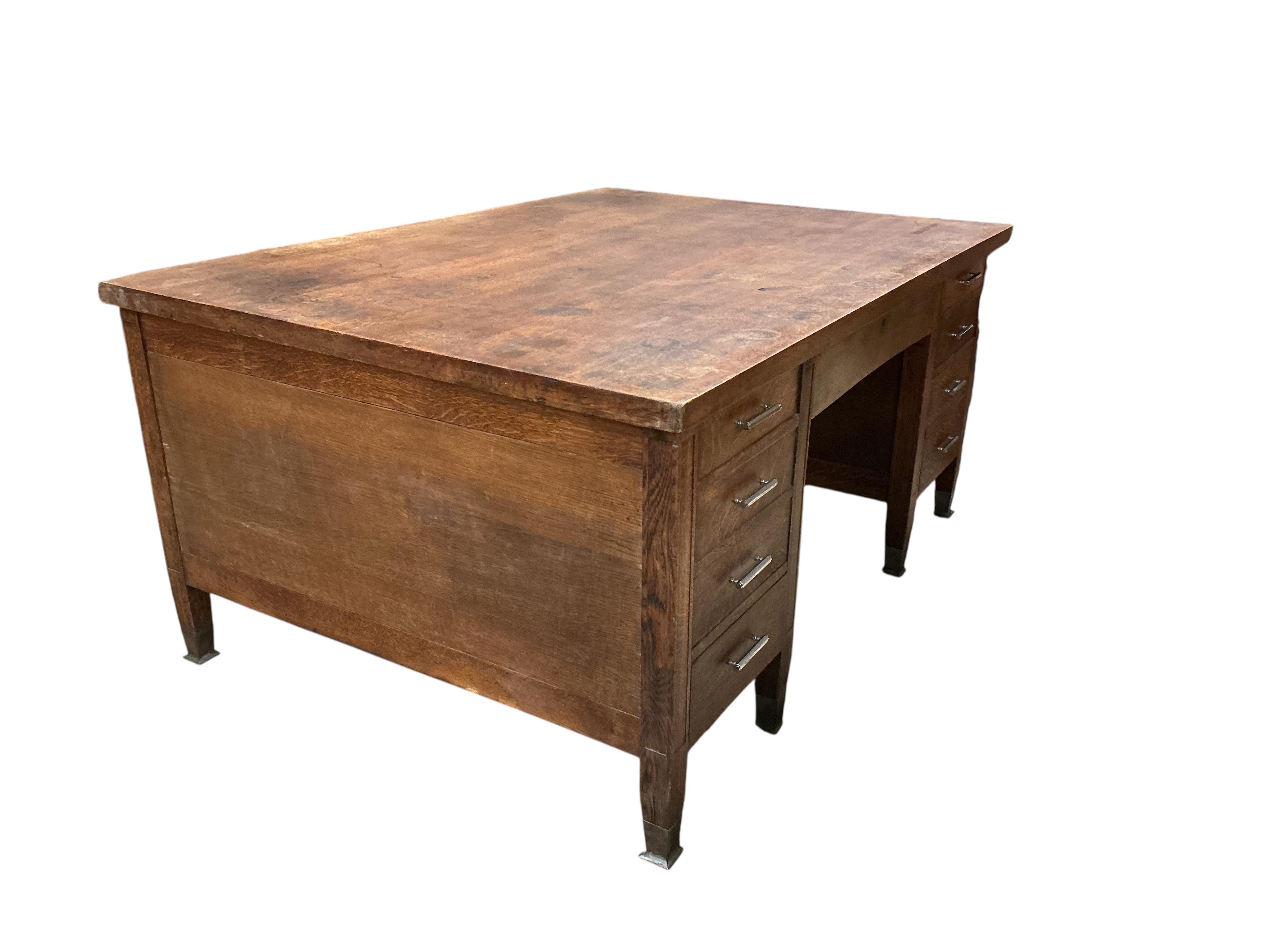 An early 20th century Continental oak kneehole partner's desk, width 168cm, depth 122cm, height 79cm